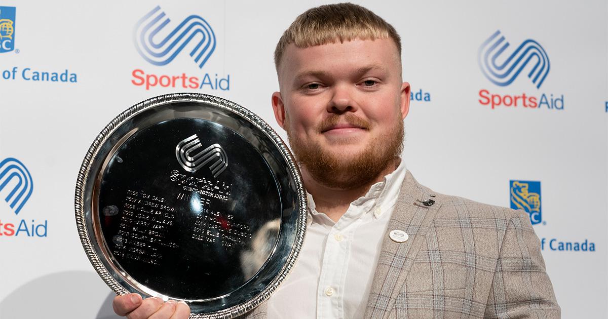 Mark holding winners trophy